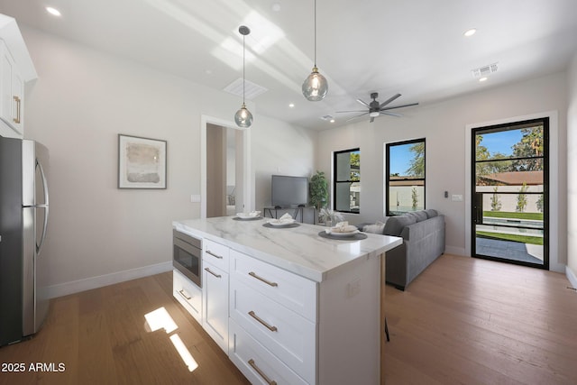 6126 E Charter Oak Rd, Scottsdale, AZ 85254 - kitchen with appliances with stainless steel finishes, light wood-style flooring, recessed lighting, white cabinets, and light stone counters