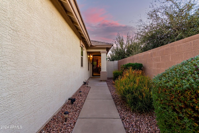 view of exterior entry at dusk