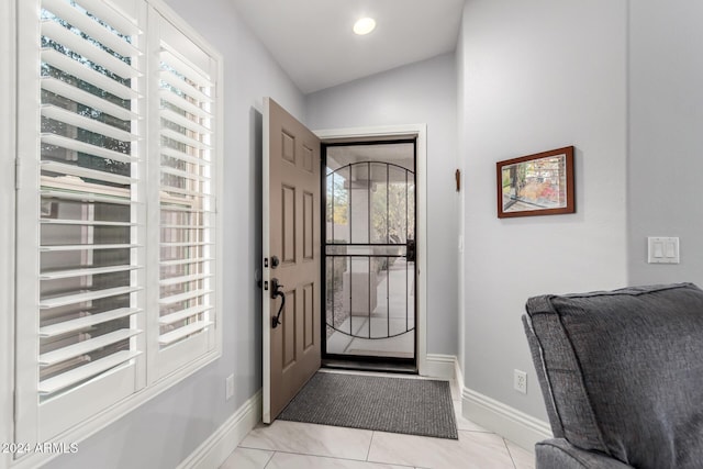 foyer entrance featuring vaulted ceiling