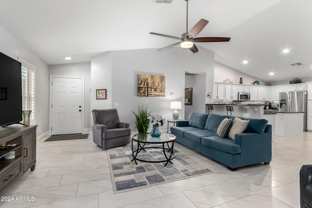 tiled living room featuring ceiling fan and lofted ceiling