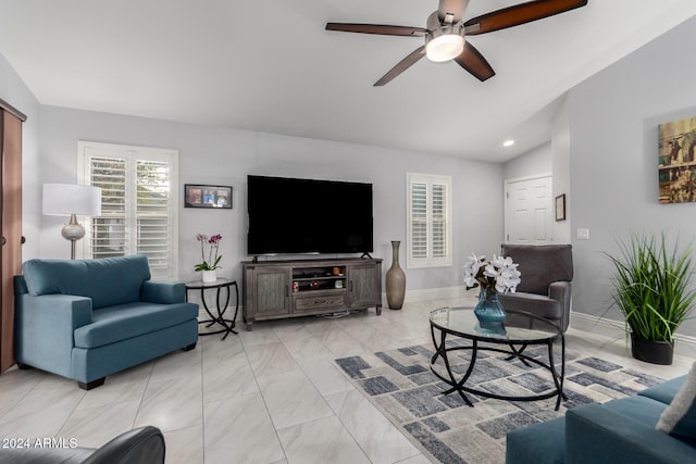 living room with ceiling fan and vaulted ceiling