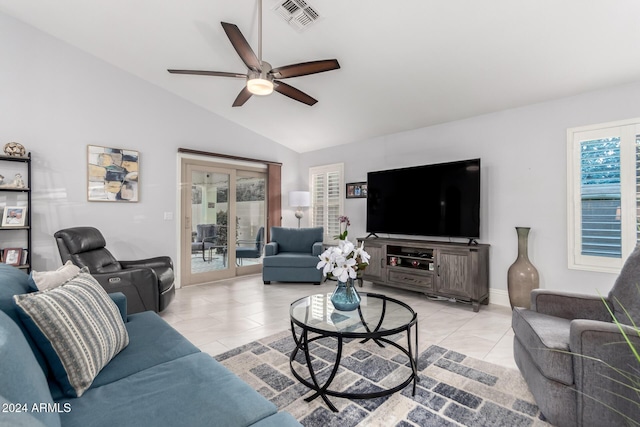 living room with ceiling fan, light tile patterned flooring, lofted ceiling, and a wealth of natural light