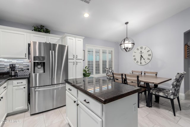 kitchen with backsplash, a center island, white cabinets, and stainless steel refrigerator with ice dispenser