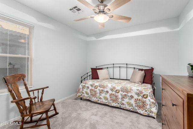 bedroom with ceiling fan and light carpet