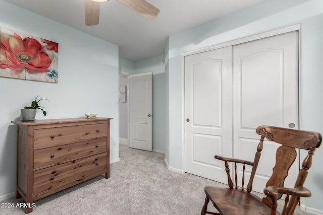 sitting room featuring light colored carpet and ceiling fan