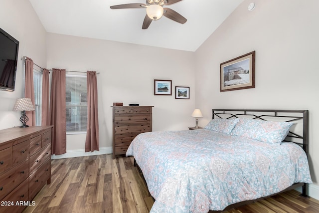 bedroom with hardwood / wood-style flooring, ceiling fan, and vaulted ceiling