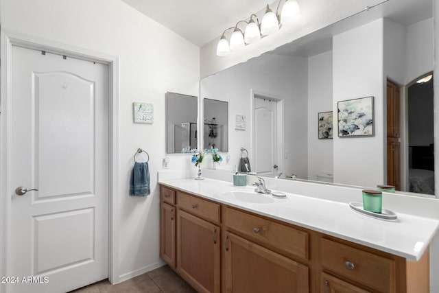 bathroom featuring tile patterned flooring, vanity, toilet, and a shower with door