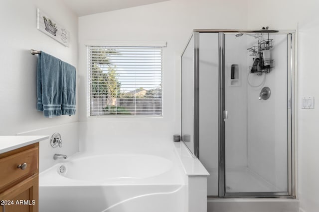 bathroom with separate shower and tub, vanity, and lofted ceiling