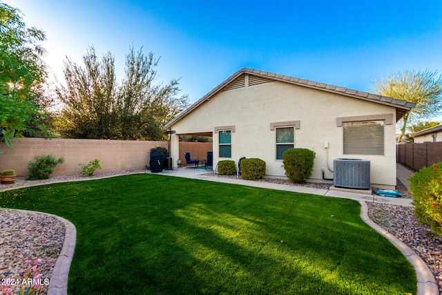 back of house with a yard, a patio, and cooling unit