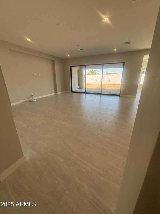 empty room with recessed lighting, baseboards, and visible vents