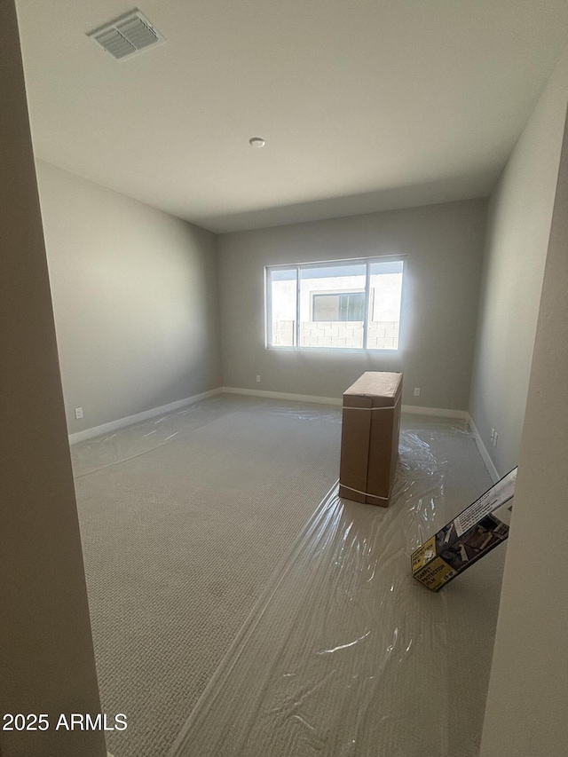 empty room with visible vents and baseboards