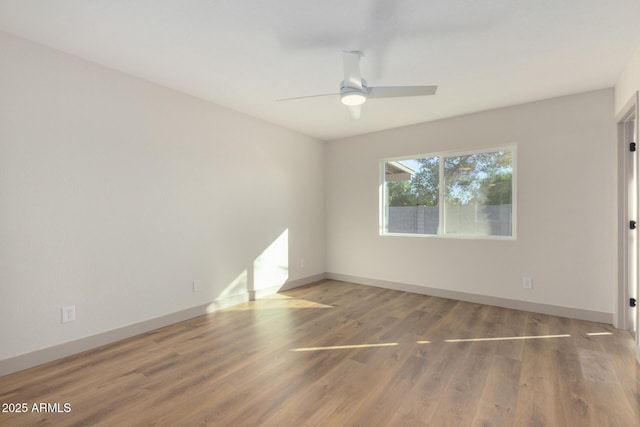 empty room with hardwood / wood-style flooring and ceiling fan