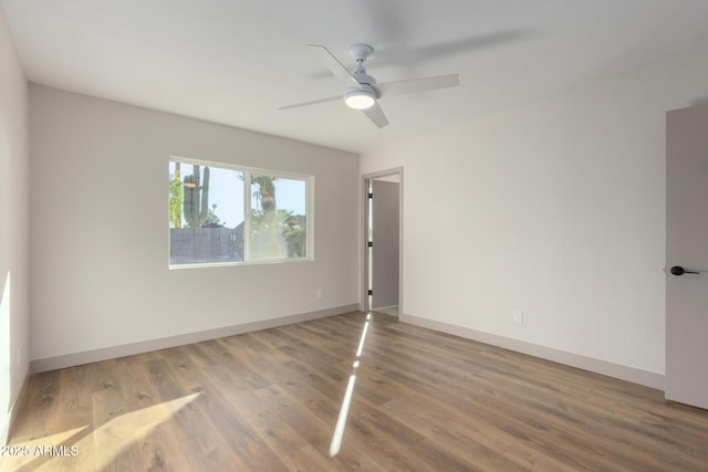 spare room featuring hardwood / wood-style floors and ceiling fan