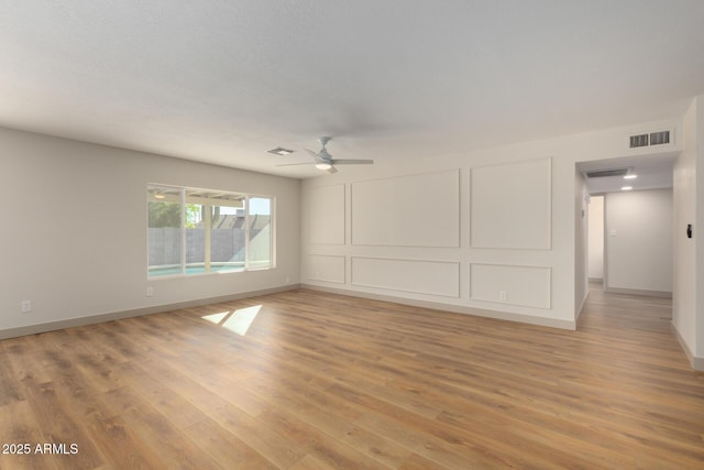 empty room featuring light hardwood / wood-style flooring and ceiling fan