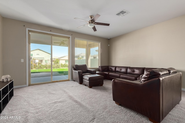 carpeted living room featuring ceiling fan