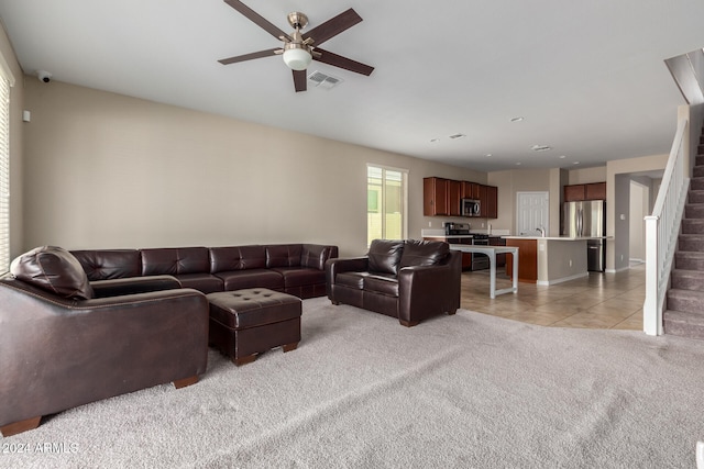 living room featuring ceiling fan and light colored carpet