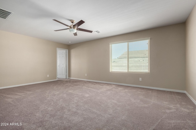 spare room featuring carpet and ceiling fan