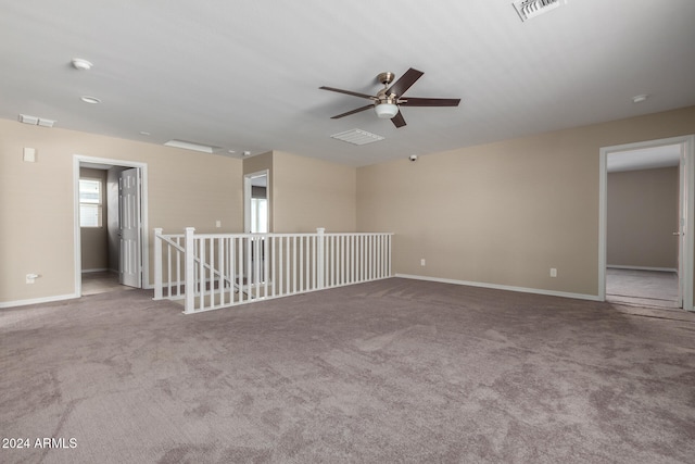 carpeted spare room with ceiling fan