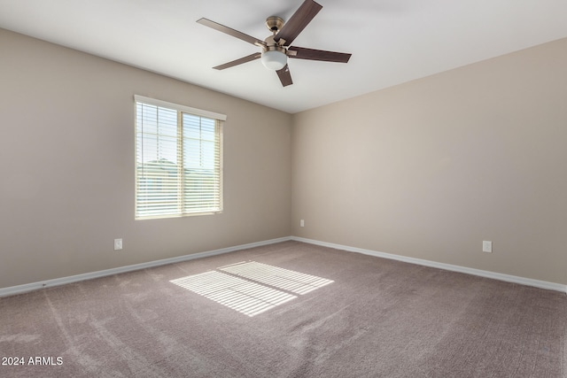 unfurnished room featuring light colored carpet and ceiling fan