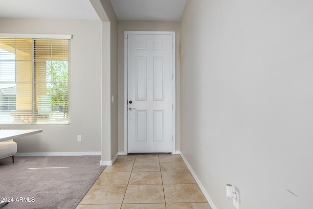 doorway to outside featuring light tile patterned flooring