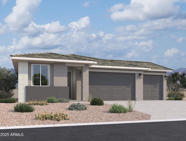 view of front of house featuring driveway, an attached garage, and stucco siding