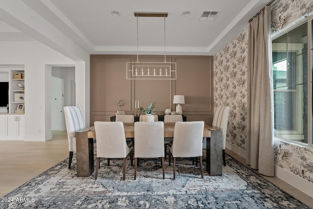 dining area featuring a raised ceiling and hardwood / wood-style floors