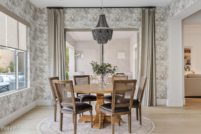 dining room featuring an inviting chandelier and light wood-type flooring