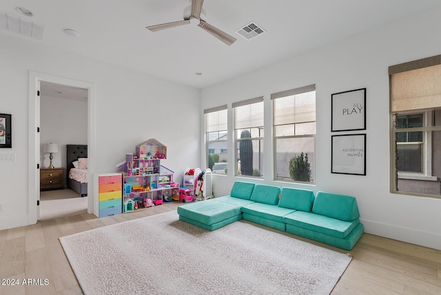 living room with ceiling fan and light wood-type flooring