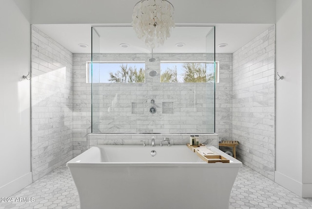 bathroom featuring tile walls, tile patterned floors, and a bathing tub