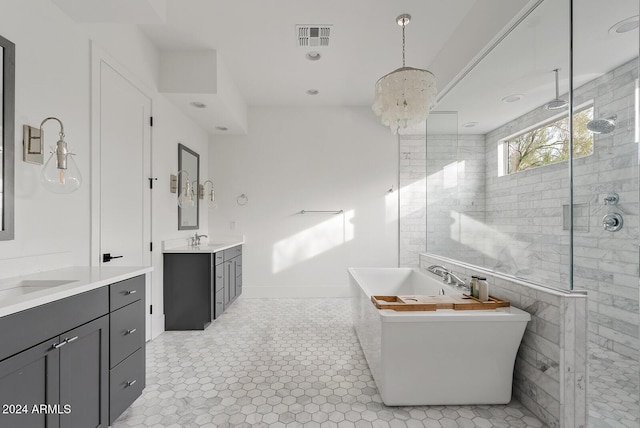 bathroom featuring vanity and shower with separate bathtub