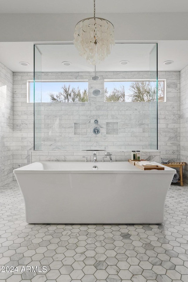 bathroom featuring a bath and tile walls