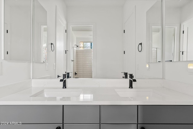 bathroom with walk in shower and vanity