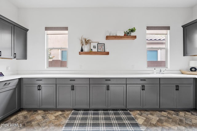 interior space featuring plenty of natural light, sink, and gray cabinetry