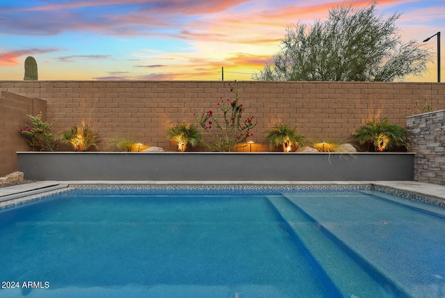 view of pool at dusk