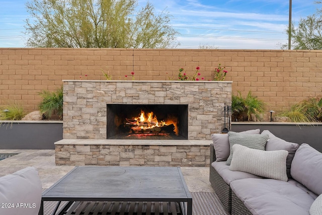 view of patio featuring an outdoor living space with a fireplace