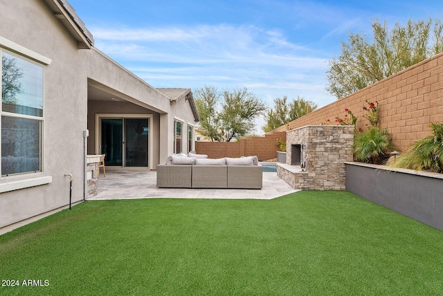 view of yard featuring a patio and an outdoor living space with a fireplace