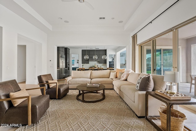 living room with a towering ceiling and a tray ceiling