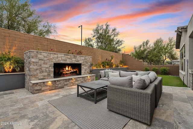 patio terrace at dusk featuring an outdoor living space with a fireplace