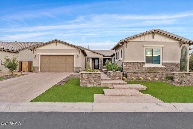 view of front of property with a garage and a front lawn