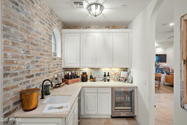 10799 E Florence Way, Scottsdale, AZ 85262 - bar featuring brick wall, visible vents, a dry bar, wine cooler, and a sink