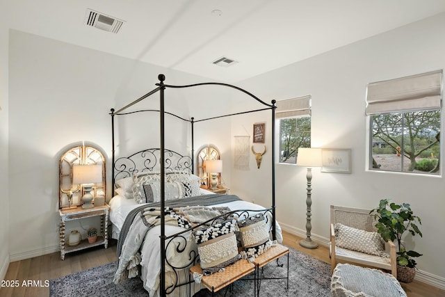 10799 E Florence Way, Scottsdale, AZ 85262 - bedroom with wood finished floors, baseboards, and visible vents