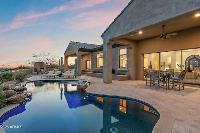 10799 E Florence Way, Scottsdale, AZ 85262 - pool at dusk featuring a patio, an outdoor pool, and ceiling fan