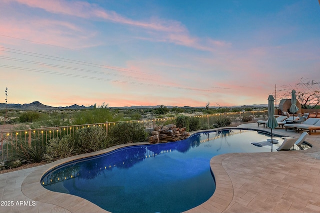 10799 E Florence Way, Scottsdale, AZ 85262 - pool at dusk featuring a patio, a mountain view, a fenced in pool, and fence