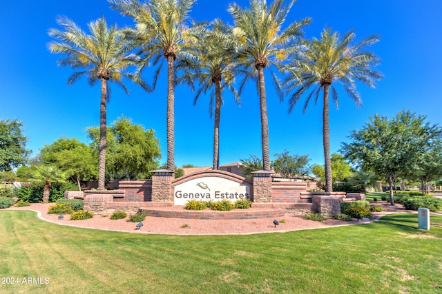 community sign featuring a lawn