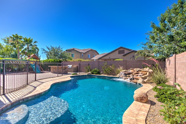 view of swimming pool featuring pool water feature and a playground