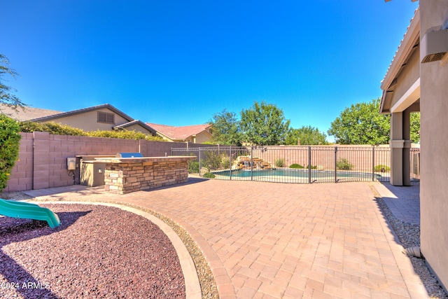 view of patio featuring exterior bar and area for grilling