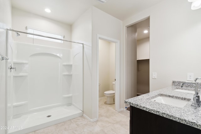 5516 E Mearn Rd, San Tan Valley, AZ 85140 - full bathroom with a shower stall, toilet, double vanity, tile patterned floors, and a spacious closet