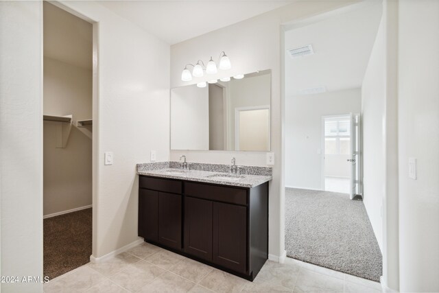 5516 E Mearn Rd, San Tan Valley, AZ 85140 - bathroom with double vanity, baseboards, and a walk in closet