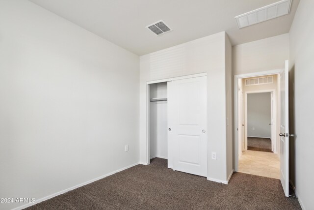 5516 E Mearn Rd, San Tan Valley, AZ 85140 - unfurnished bedroom featuring dark colored carpet, a closet, and baseboards