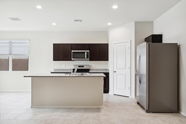 5516 E Mearn Rd, San Tan Valley, AZ 85140 - kitchen with appliances with stainless steel finishes, recessed lighting, dark brown cabinetry, a center island with sink, and baseboards